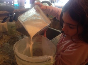 Pouring milk into the nut bag